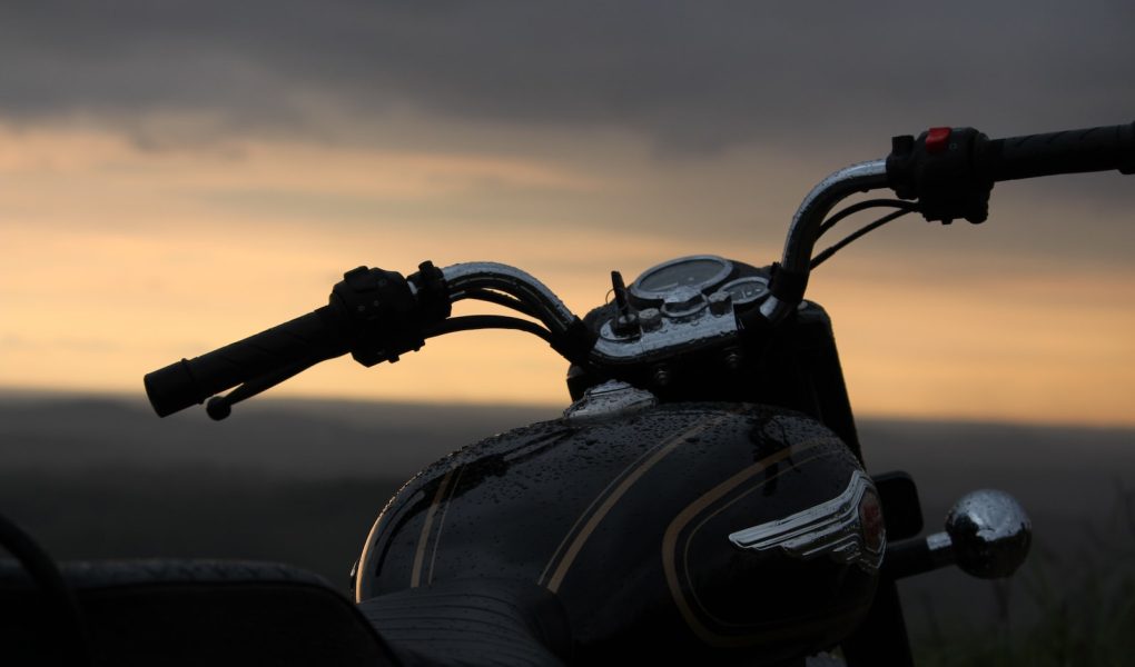 black motorcycle on the beach during sunset