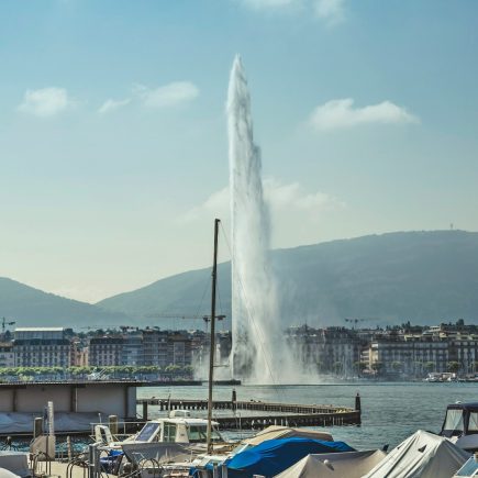 water fountain near city buildings during daytime