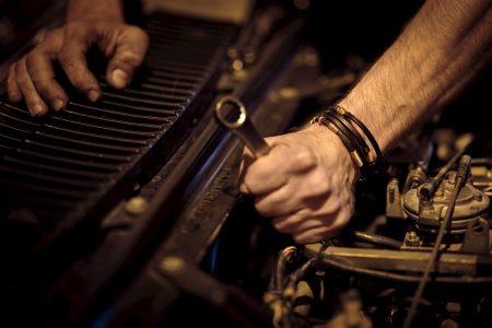 grayscale photo of person playing piano
