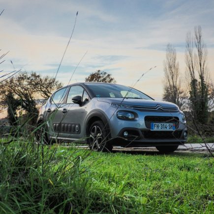 blue bmw m 3 coupe on green grass field during daytime
